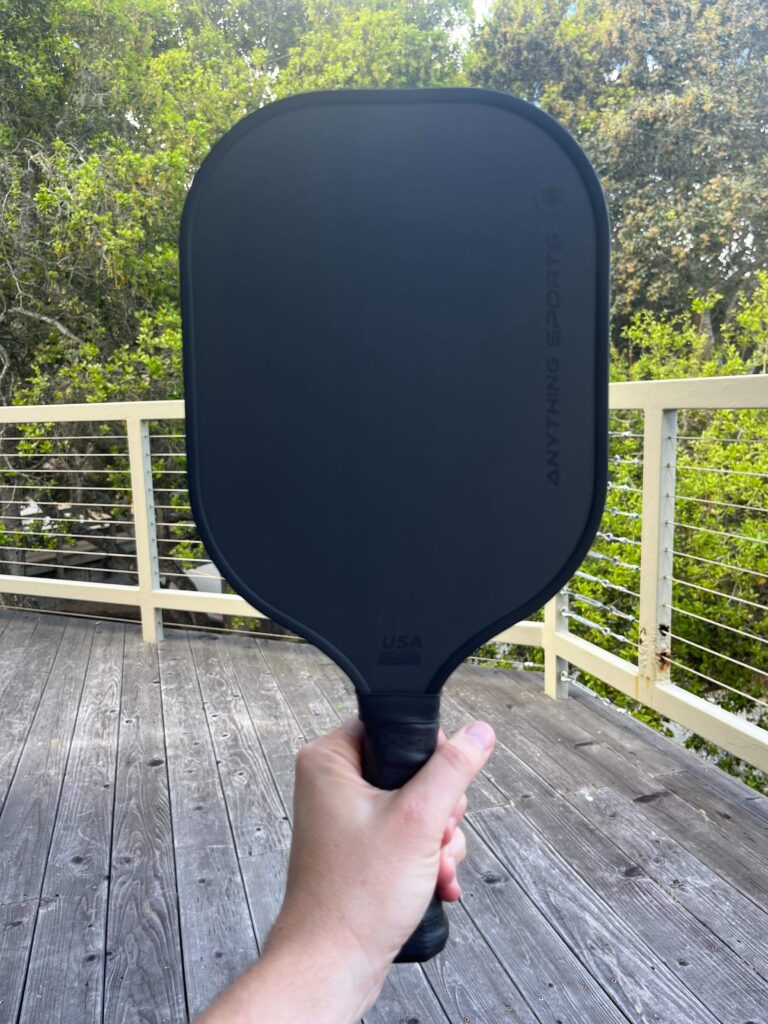Picture of man holding the Anything Sports carbon fiber paddle.