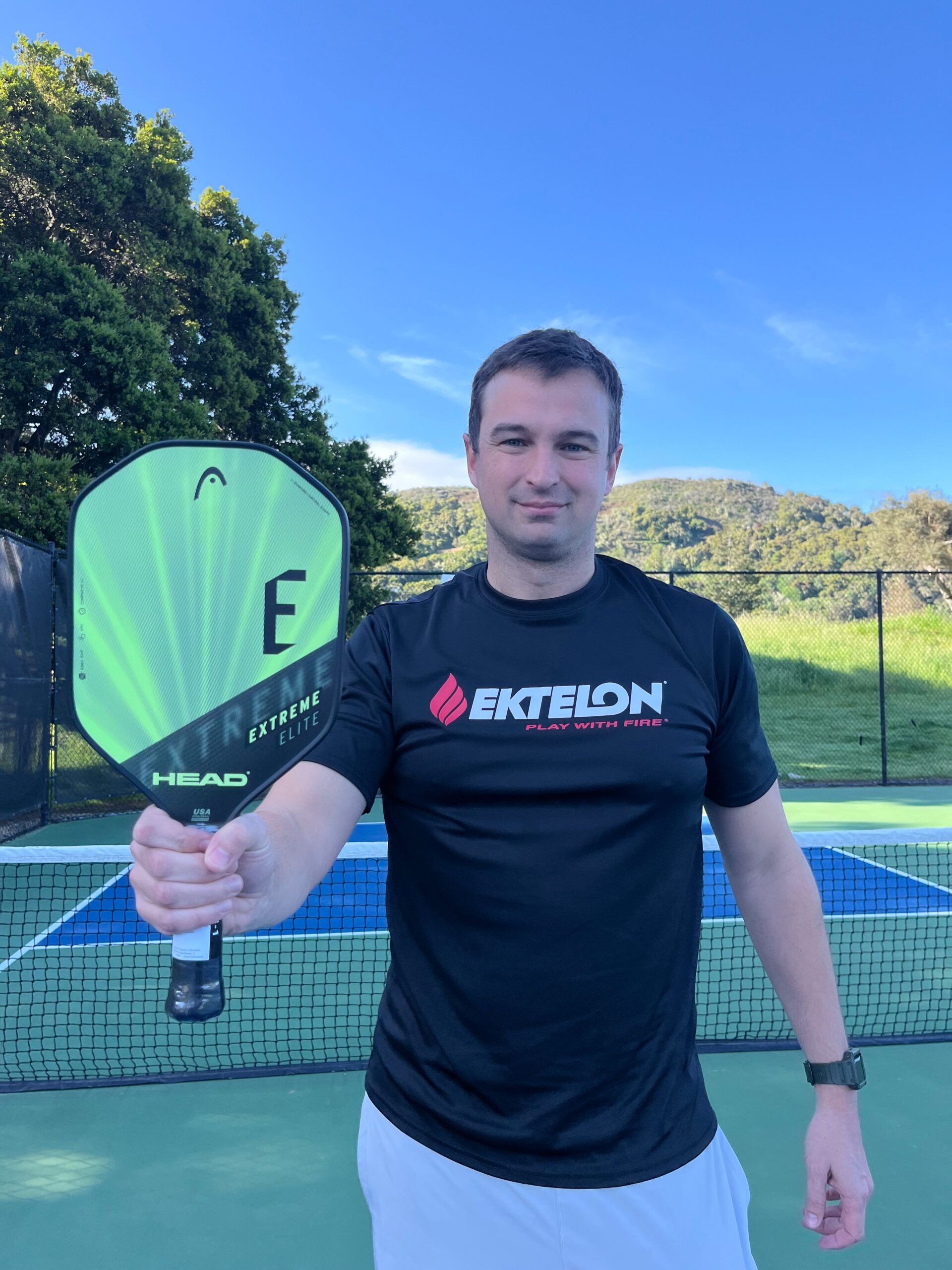 Picture of man holding the Head radical elite pickleball paddle