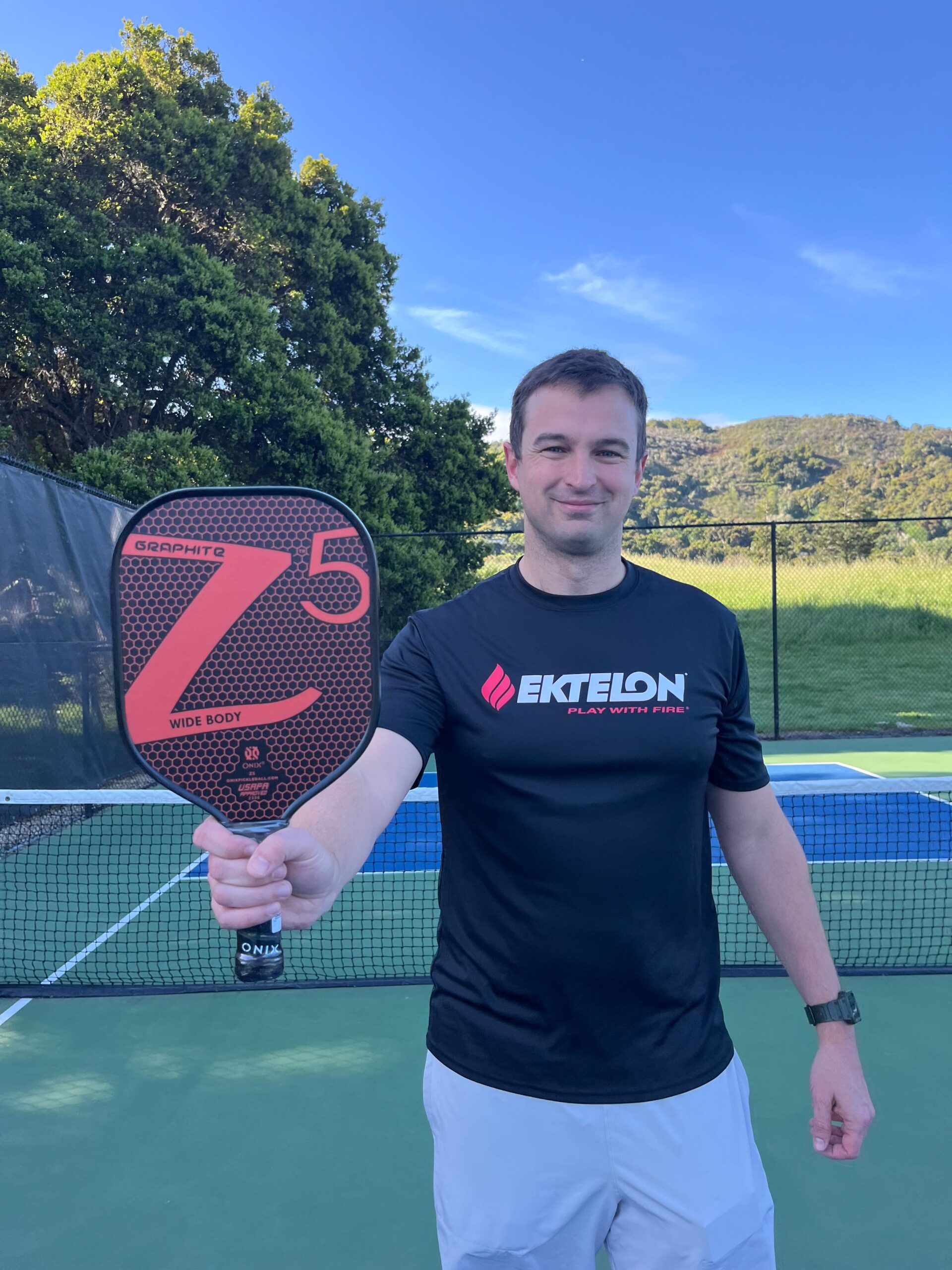 Picture of man holding the Onix Z5 graphite pickleball paddle