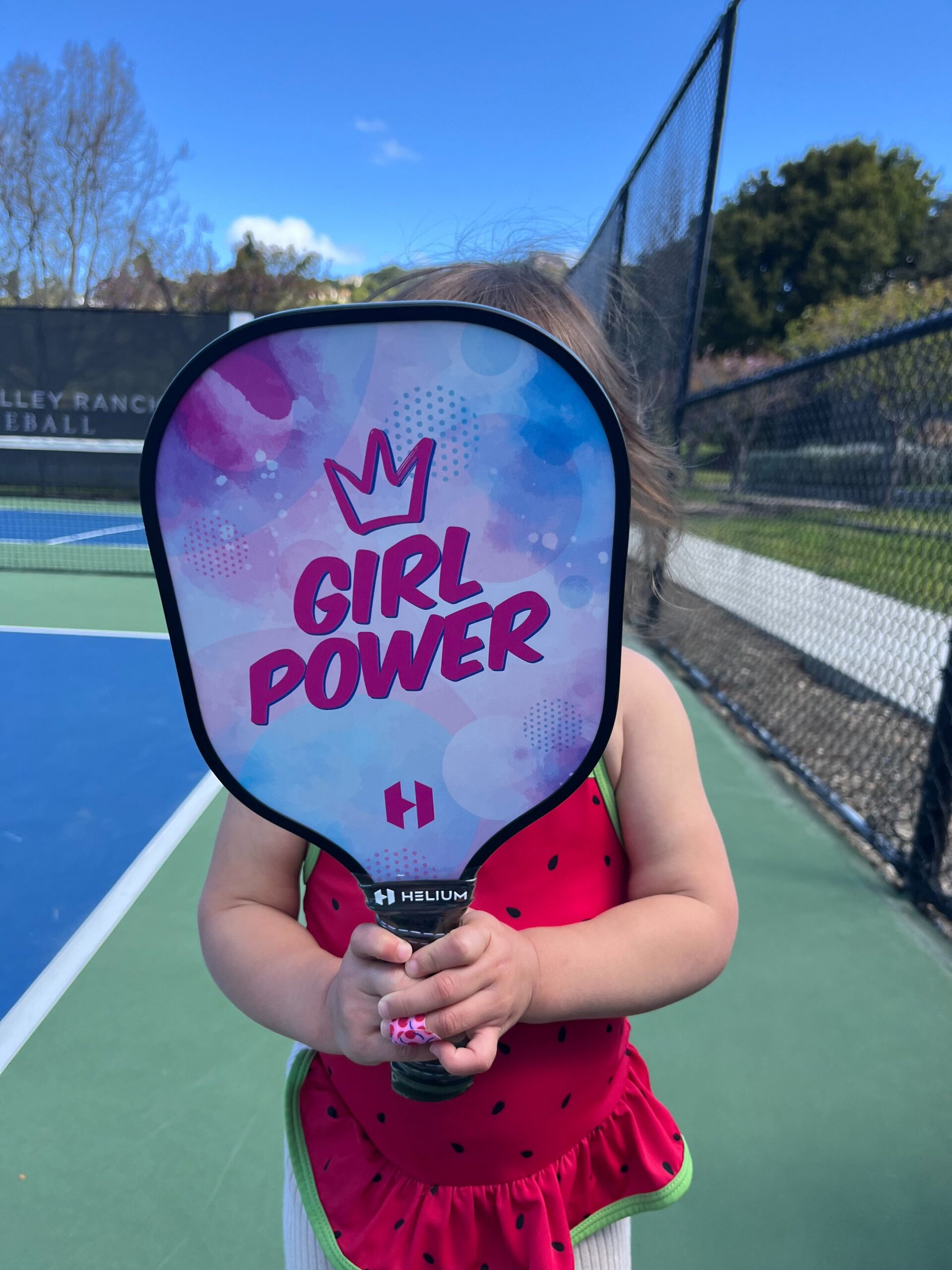 Picture of kid holding kid's pickleball paddle.