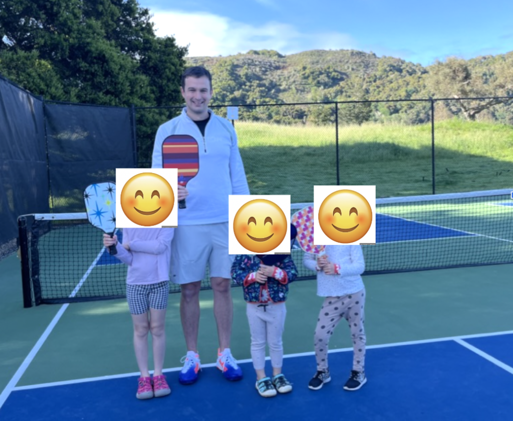 Picture of man going through pickleball drills with 3 kids