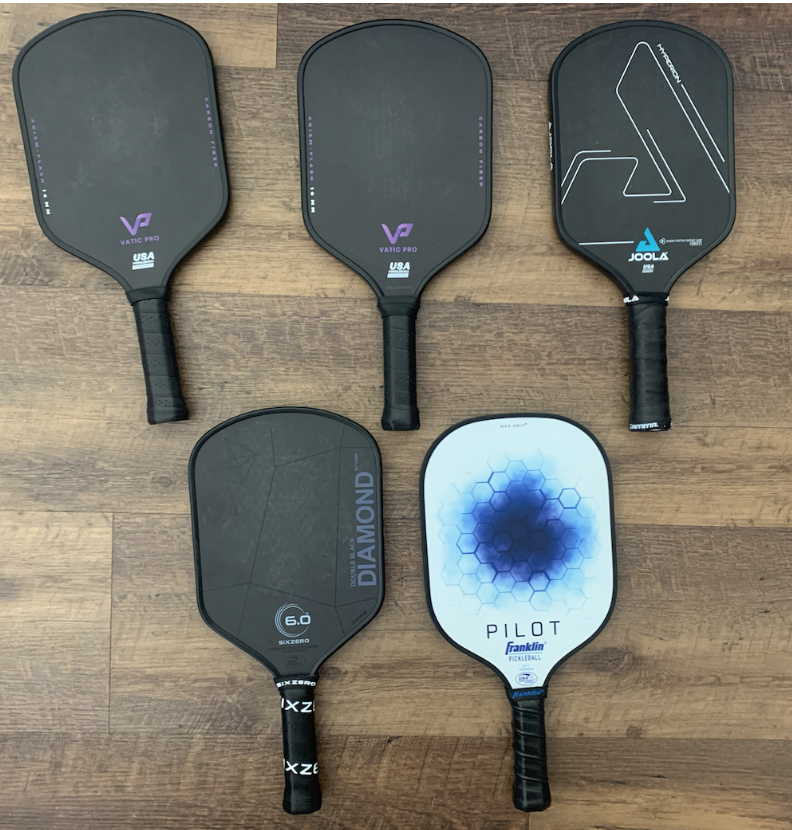 Picture of used pickleball paddles.