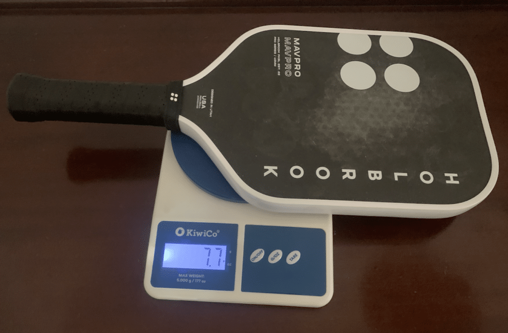 Picture of the Mav Pro 2.0 pickleball paddle on the scale weighing 7.7 ounces