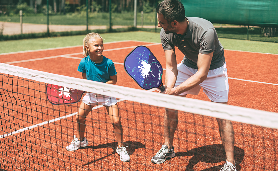 Picture of father and kid playing with pickleball paddle