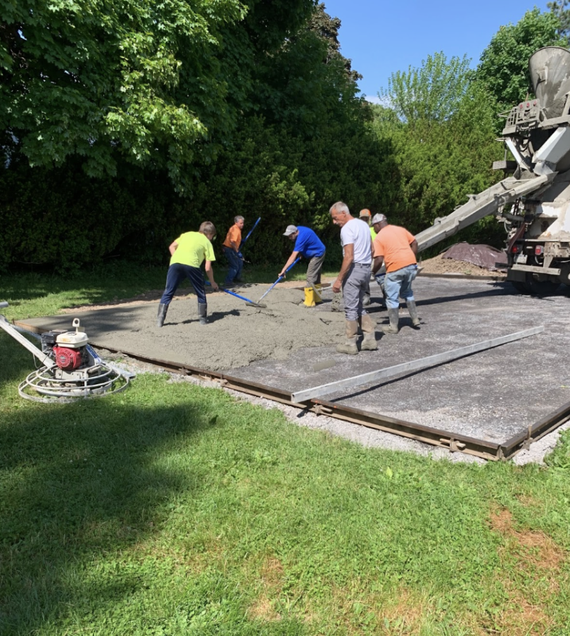 Picture of contractors laying concrete for a backyard pickleball court