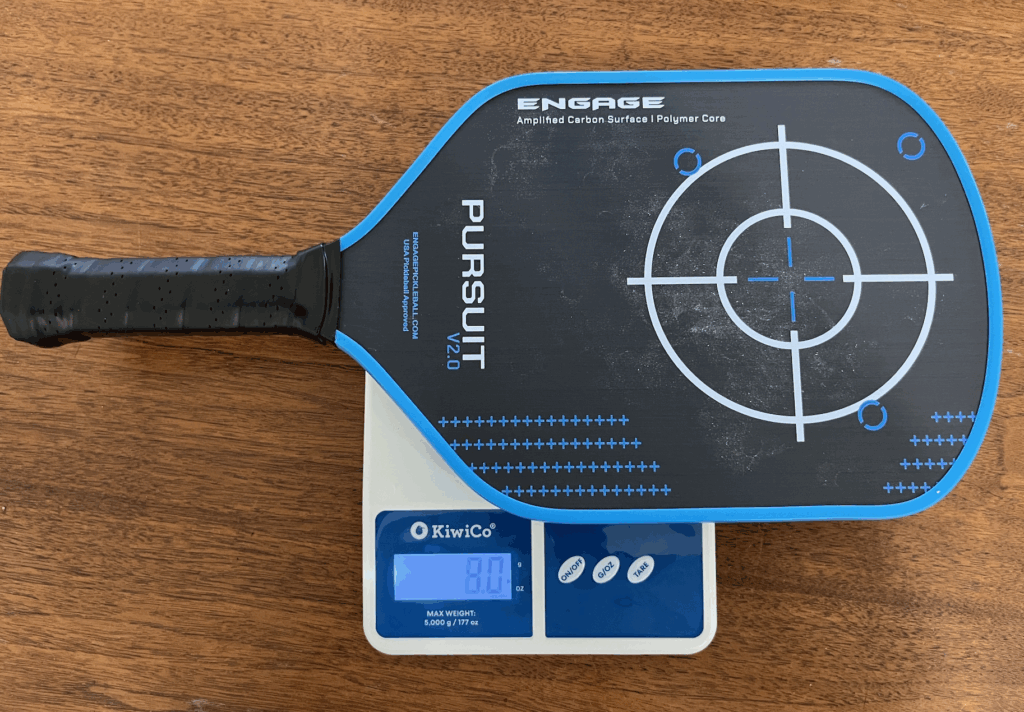 Picture of the Engage Pursuit V2.0 pickleball paddle on the weight scale.