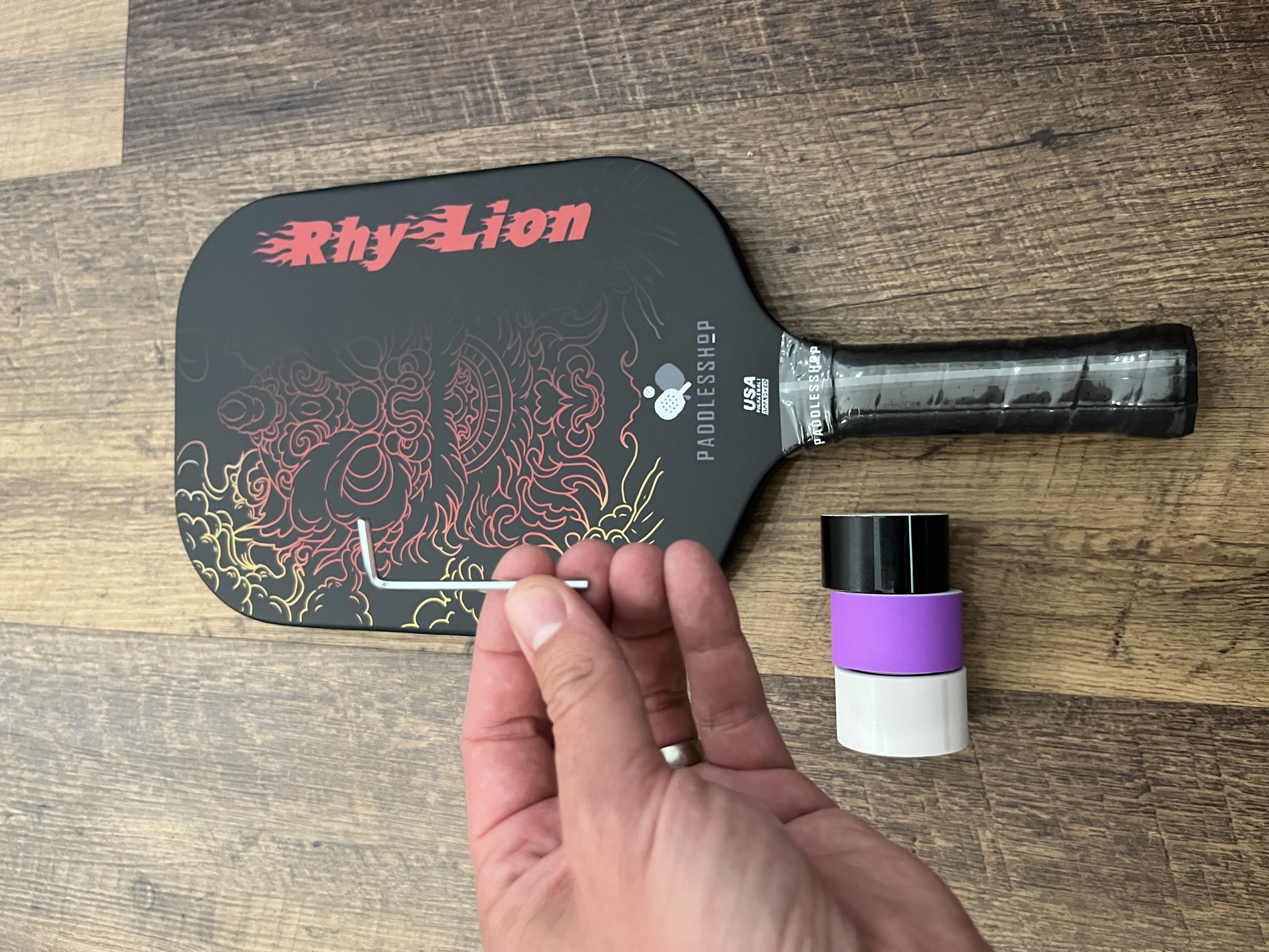 Close up picture of a tool and the Paddlesshop Rhylion pickleball paddle.