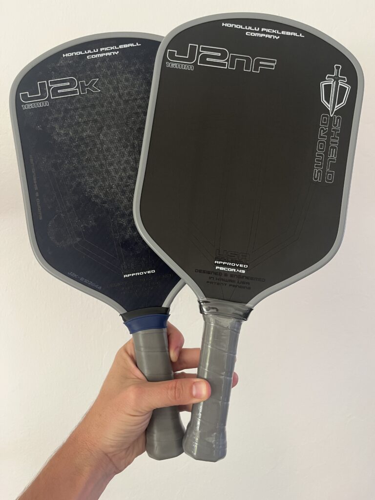 Picture of J2K vs J2NF pickleball paddle side by side next to each other.