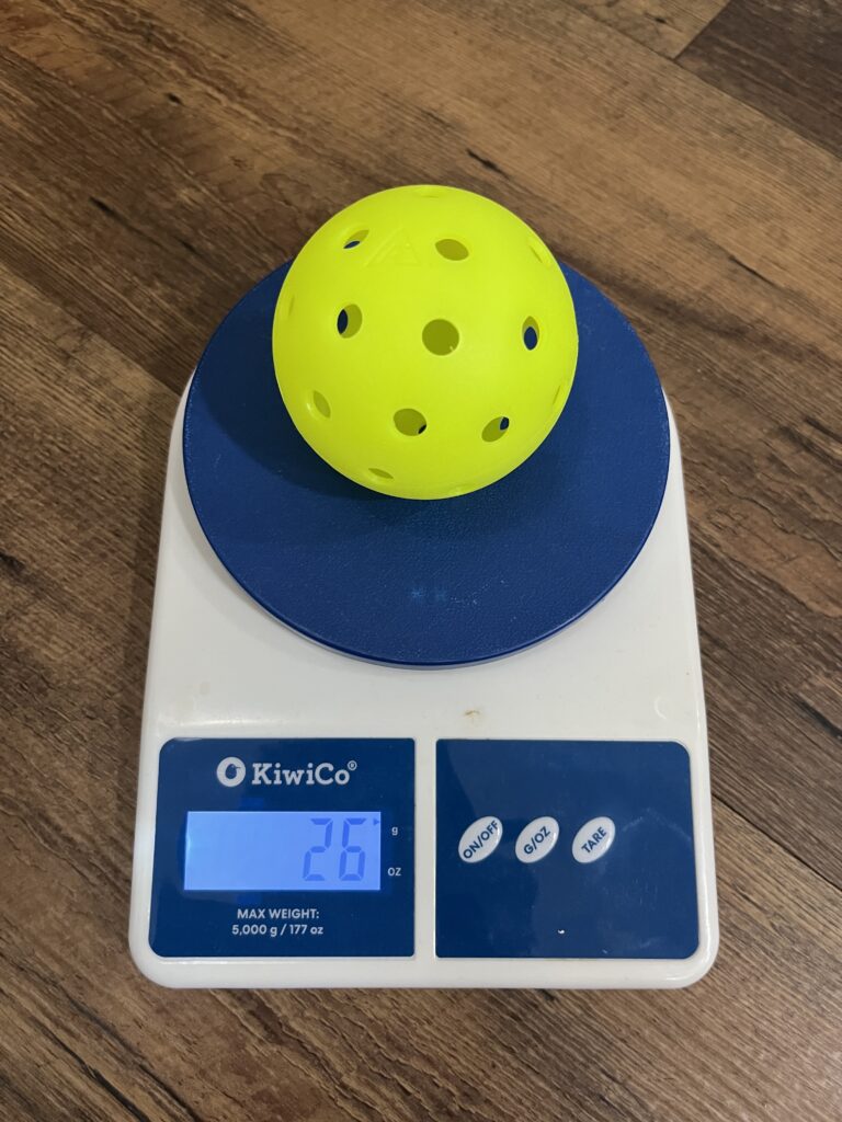Picture of the Joola Primo HC-40 outdoor pickleball ball on the scale.